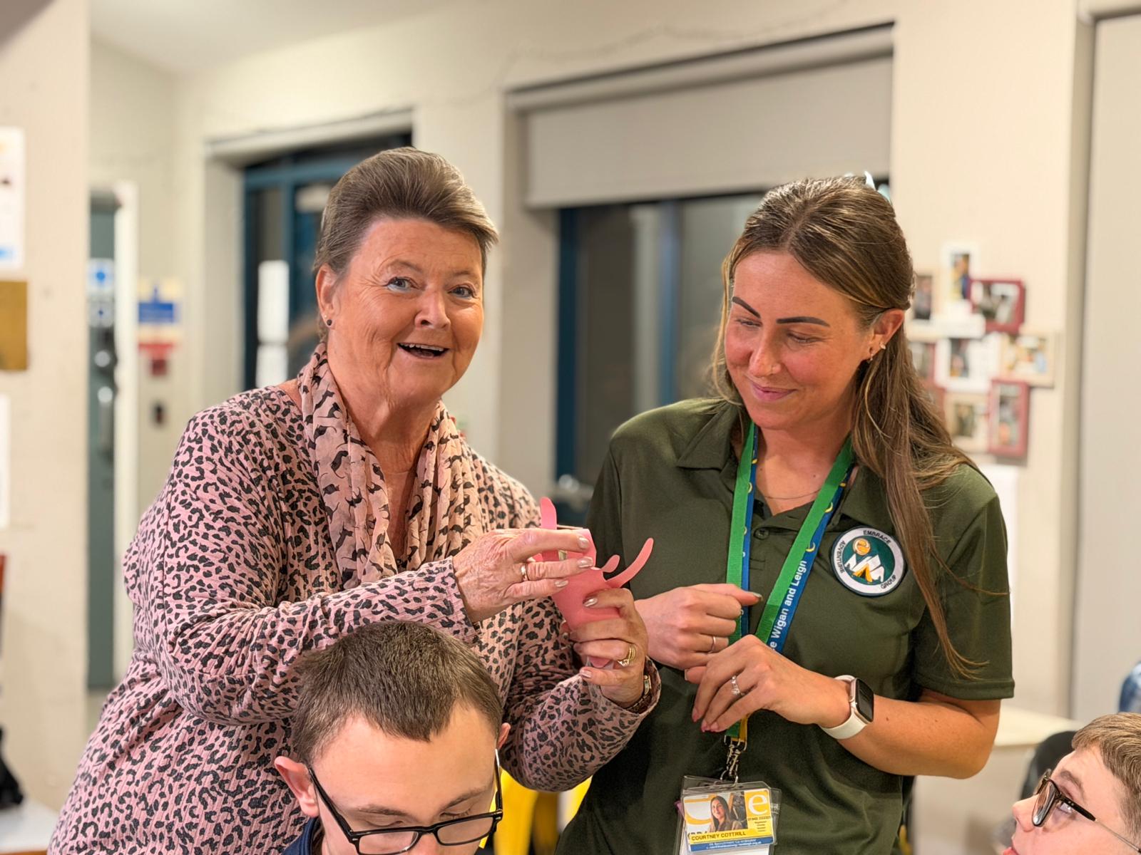 three people completing crafts at the adventure group